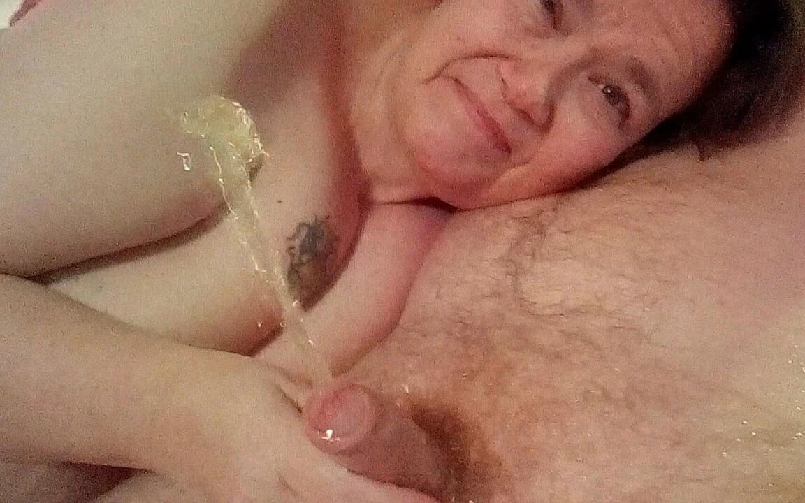 John is Pissing when Jen is giving him a Handjob on the Bed