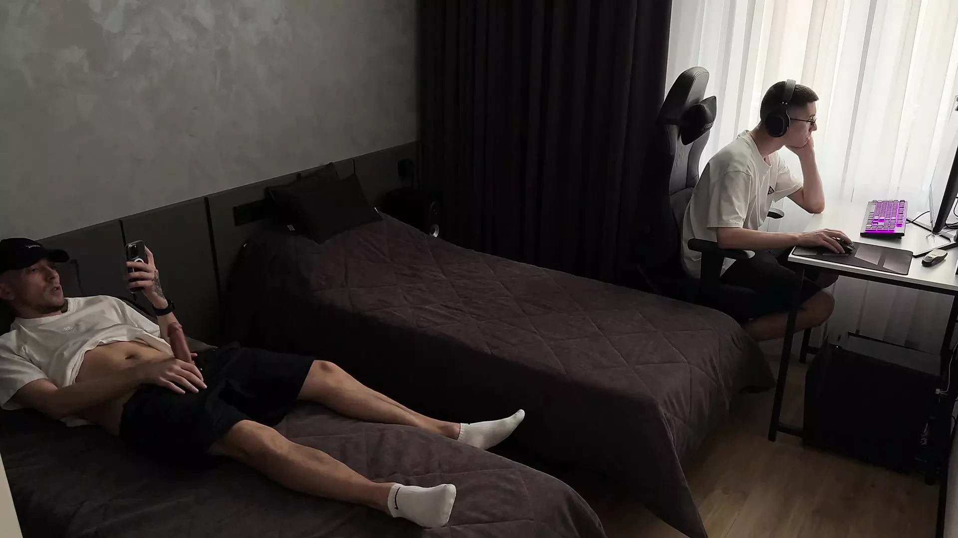 Guy jerks off dick while his friend is busy