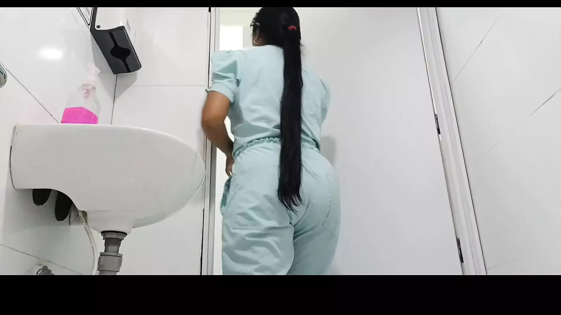 Amateur camera in public bathroom captures nurse pissing